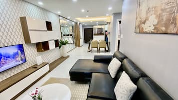 Family Apartment | Living area | 60-inch flat-screen TV with cable channels, TV, first-run films