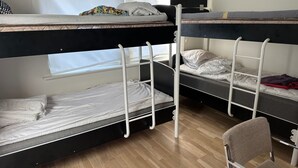 A bunk bed room with a window, a chair, and a wooden floor. - Apartment in Kista, Stockholm (Kista)