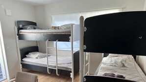 A dormitory room with bunk beds, a wooden floor, a chair, and a window. - Apartment in Kista, Stockholm (Kista)