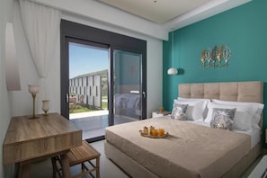 Relax in comfort with a large bed and a desk for work, offering a view of the landscaped garden.