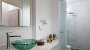 A modern bathroom with a glass bowl sink, a handheld showerhead, and a toilet. - Deluxe Villa Konstantinos (Malevizi)