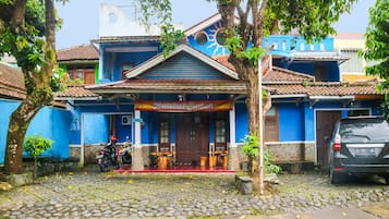 A building with a blue facade, a tiled roof, and a sign reading "Baleat Eendah".