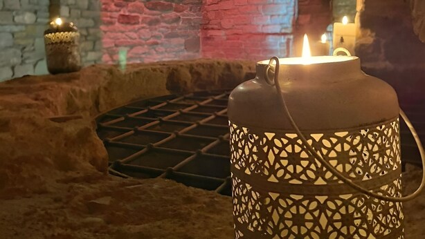 A candle-lit interior with stone walls and an arched ceiling. - Il Castello di Bubbio (Bubbio)