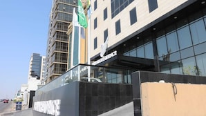A modern building with a glass facade and a sign reading "RESIDENCE". - Dream Residence (Al Khobar)