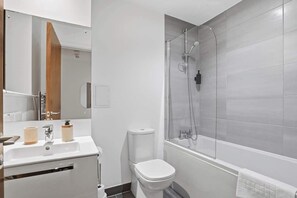 Ein modernes Badezimmer mit Dusche, Toilette und Waschbecken.