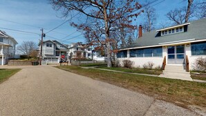 A residential street with houses, a stop sign, and a sidewalk. - FT Away From Lake MI Beaches Golf Tennis Park Trails & More Dog Friendly New AC (New Buffalo)