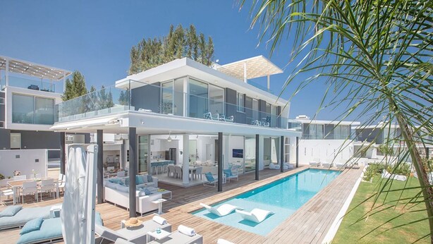 A modern two-story house with a large pool, outdoor seating, and a covered patio area. - The Ultimate 5 Star Holiday Villa in Protaras With Private Pool and Close to the Beach, Protaras Villa 1583 (Paralimni)