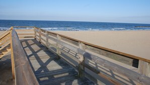 A wooden boardwalk leading to a sandy beach with the ocean in the background. - Cozy Suite - Pet Friendly, Beach Side 1 Bedroom Apts by RedAwning (Norfolk)