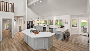 A spacious kitchen with a large island, modern appliances, and a view of the outdoors. - 20 Acres + Pool + Game Room | Paso Wine Country | Oaks and Roses Ranch (Paso Robles)