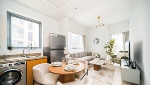 A compact living space with a kitchen, dining area, and seating.