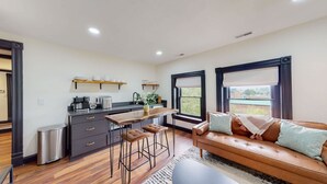 A compact living space with a kitchenette, a sofa, and a dining area. - King Beds|Parking|0.6 miles from UofL|Free WiFi (Louisville)