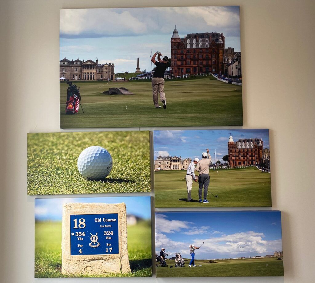 A golf course with a sign indicating hole 18, a tee box, and a building in the background.