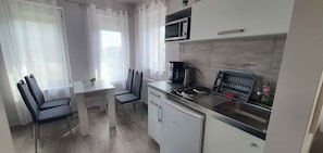 Fridge, microwave, stovetop, coffee/tea maker