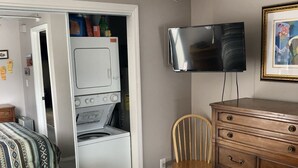 A bedroom with a bed, a dresser, a chair, a television, and a ceiling fan. - #106-Condo nearby pool and the Gorge shuttle stop (Quincy)