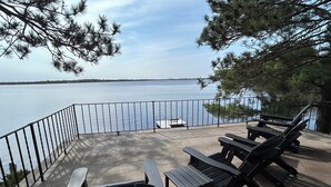 A deck with outdoor seating and a view of a lake. - Castle Rock Lakefront Home, with pier, sand bottom, and wrap around deck (Arkdale)