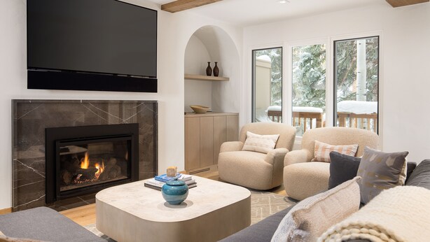 A modern living room with a fireplace, comfortable seating, and large windows. - Newly remodeled 4 bedroom condo only 1 block to Bridge St. & ski slopes, fre (Vail)