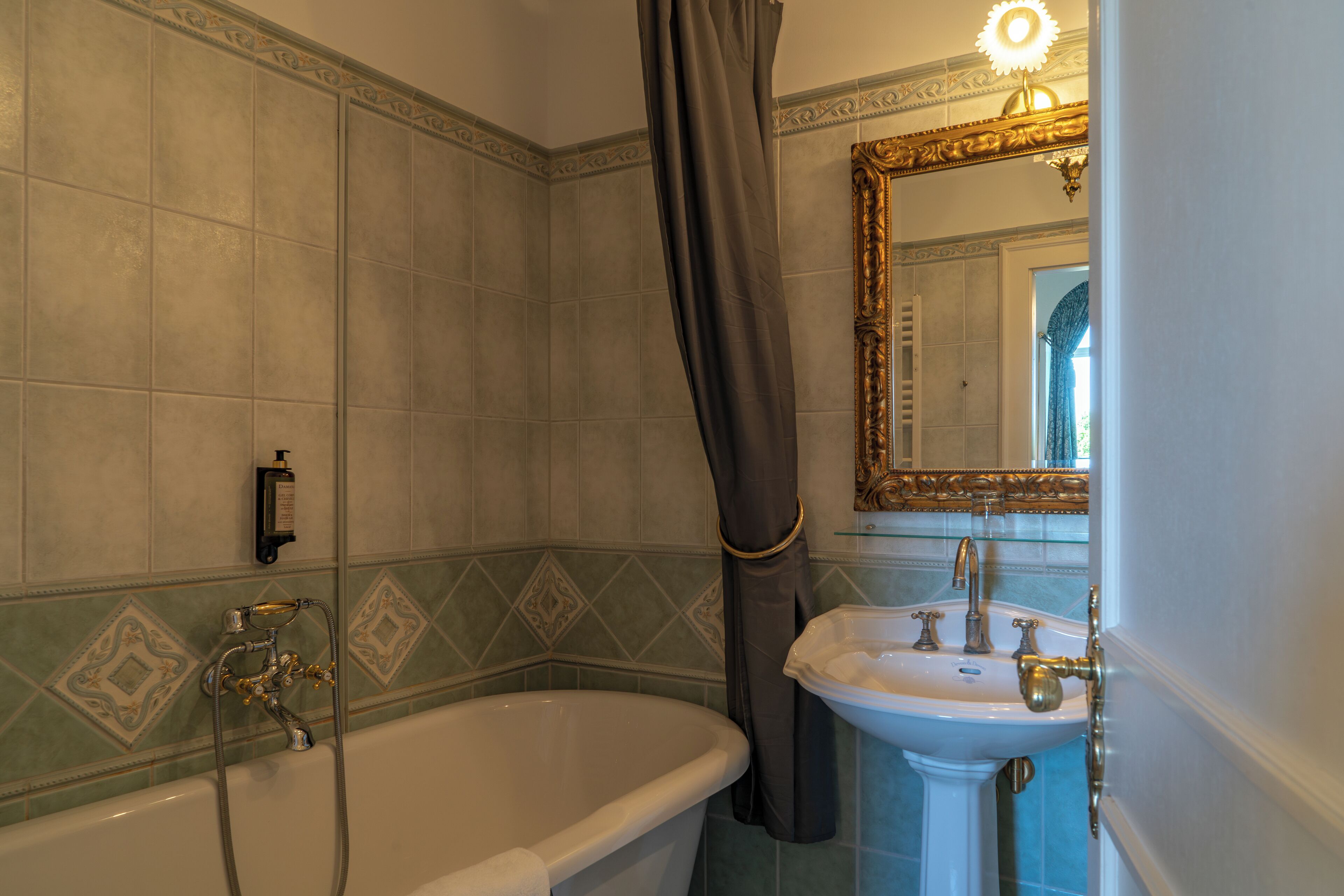 A bathroom with a bathtub, a sink, and a mirror.