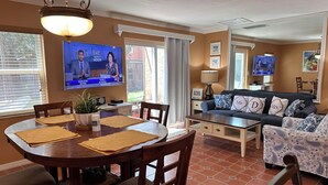 A living room with a TV, sofa, and dining area. - HOME AWAY FROM HOME -VACATION VILLA  (Kissimmee)