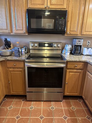 Enjoy cooking in this well-equipped kitchen with an oven, microwave, and coffee maker.
