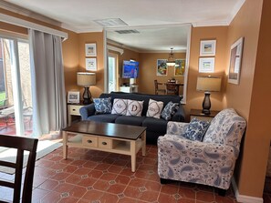 Relax in this stylish living room with a sofa, armchair, and coffee table, perfect for unwinding and enjoying the view.