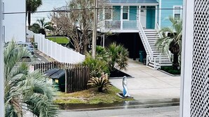 A coastal house with a porch, a lifeguard duty sign, and a chair outside. - Walk Across the Street to Beautiful Soft Sandy Beach! (Murrells Inlet)