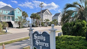 A sign for Sandy Shores II with a residential street in the background. - Walk Across the Street to Beautiful Soft Sandy Beach! (Murrells Inlet)