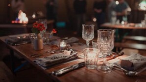 A dimly lit restaurant with tables set for dining, featuring candles and glassware. - South Dell - Scandi-style family cottage set on the edge of the Abernethy Forest (Nethy Bridge,)
