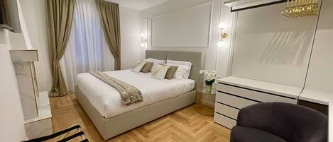 A modern bedroom with a bed, bedside table, dresser, chair, and a mirror.