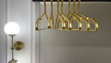 A gold-colored coat rack with multiple hooks in a modern interior setting.