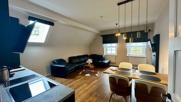 Een modern loft appartement met een eethoek, keuken en woonruimte.