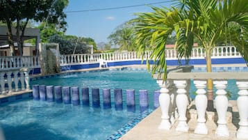 Alberca al aire libre y camastros