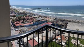 A coastal cityscape with a beach, a pier, and a view from a balcony. - Beachfront Penthouse in downtown Rosarito Beach (Rosarito)