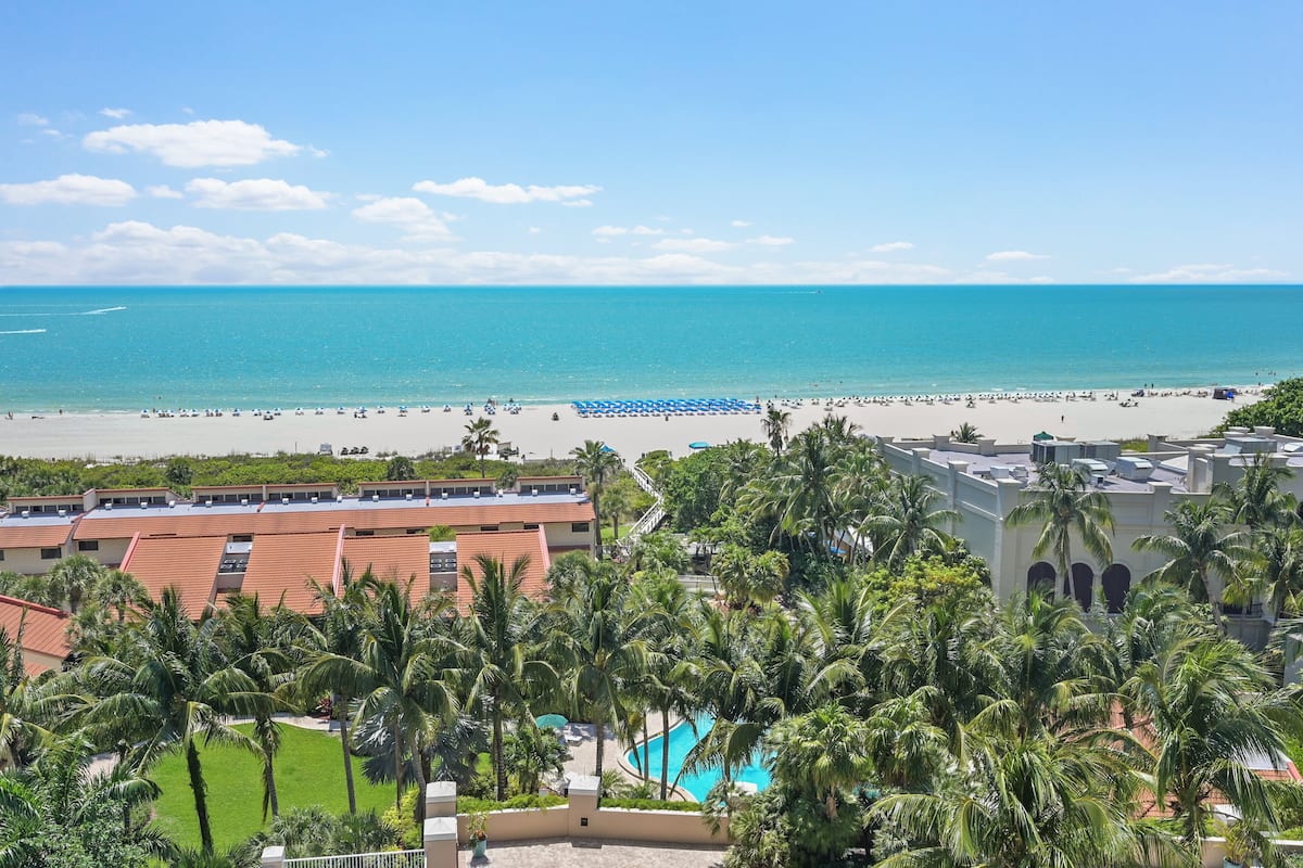 A resort with a pool, beach, and ocean view.