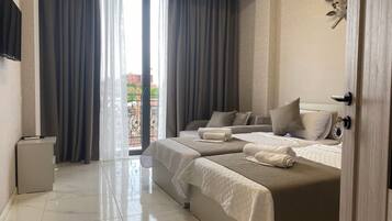 Luxury Apartment | Living area | 20-inch flat-screen TV with cable channels, TV