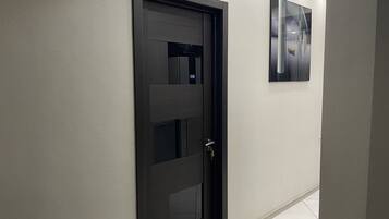 Basic Double Room | Living area | 20-inch flat-screen TV with cable channels, TV