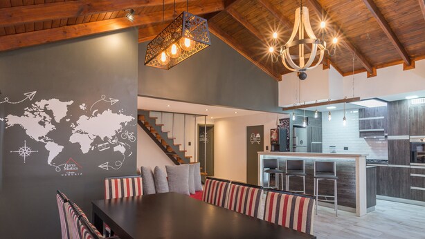 Ein modernes Interieur mit Essbereich, Küche und Treppe.