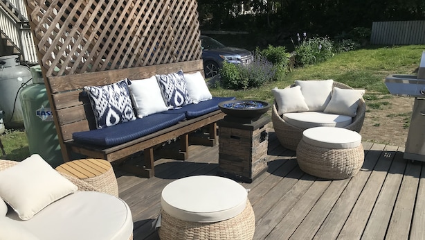 A wooden deck with outdoor furniture including a bench, two wicker chairs, and a round table. - Location Location Location walk to all the favorite Rockport  attractions  (Rockport)