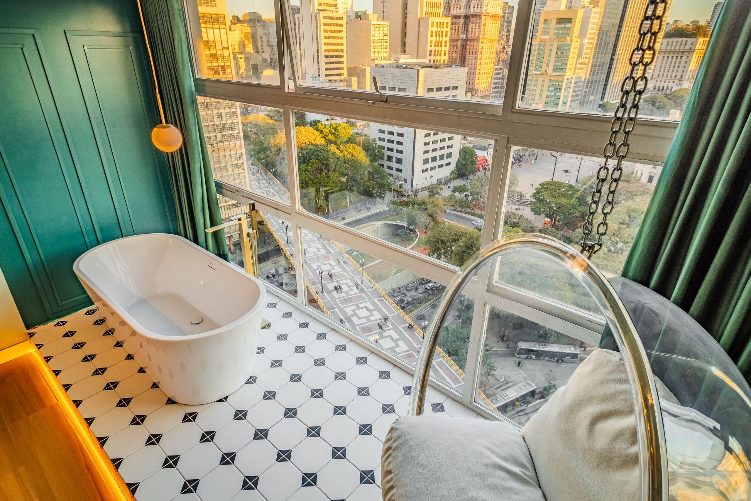 Une chambre avec une baignoire, une vue sur la ville et un sol à motifs.