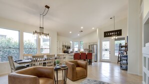 A spacious living room with a dining area, kitchen, and large windows. - Upscale Golfer's Oasis w/ Pool & Spa in Cave Creek (Cave Creek)