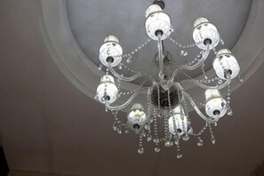 A chandelier with multiple arms and crystal elements. - Jiulong Hotel (Guilin High Speed Railway North Station Shop) (Lingchuan)