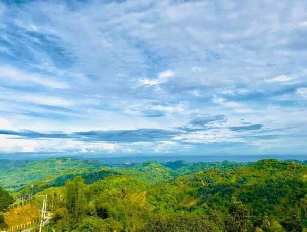 Surrounded by lush green hills and rolling terrain, this serene landscape offers a peaceful escape.