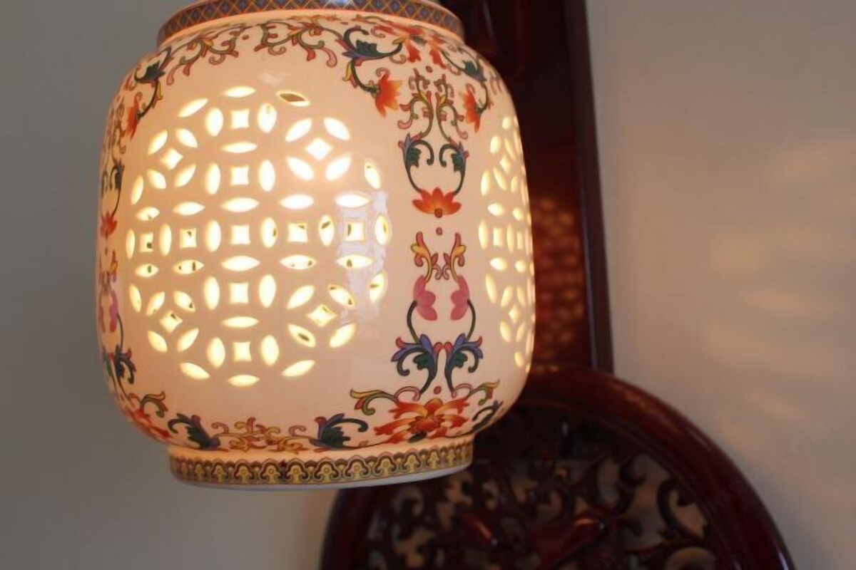 A decorative lamp with intricate patterns and a floral design.