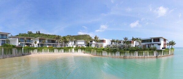 A beachfront property with modern villas, a sandy beach, and clear turquoise waters. - Villa Le Corail, A Gran Melia Hotel (Bac Nha Trang)