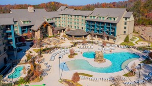 A resort with multiple buildings, a large central pool, and outdoor seating areas. - HeartSong Lodge & Resort (Pigeon Forge)