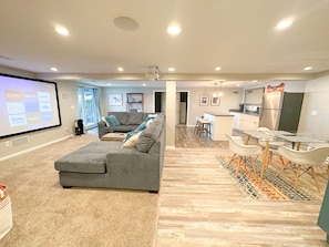 Relax in this stylish living space with a comfortable sofa, flat-screen TV, and dining area.