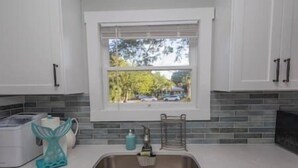 A kitchen with a window, a sink, and a countertop. - ArtSea2. 2BR · Upstairs w/Ample Parking | Near Beaches & LECOM (Bradenton)