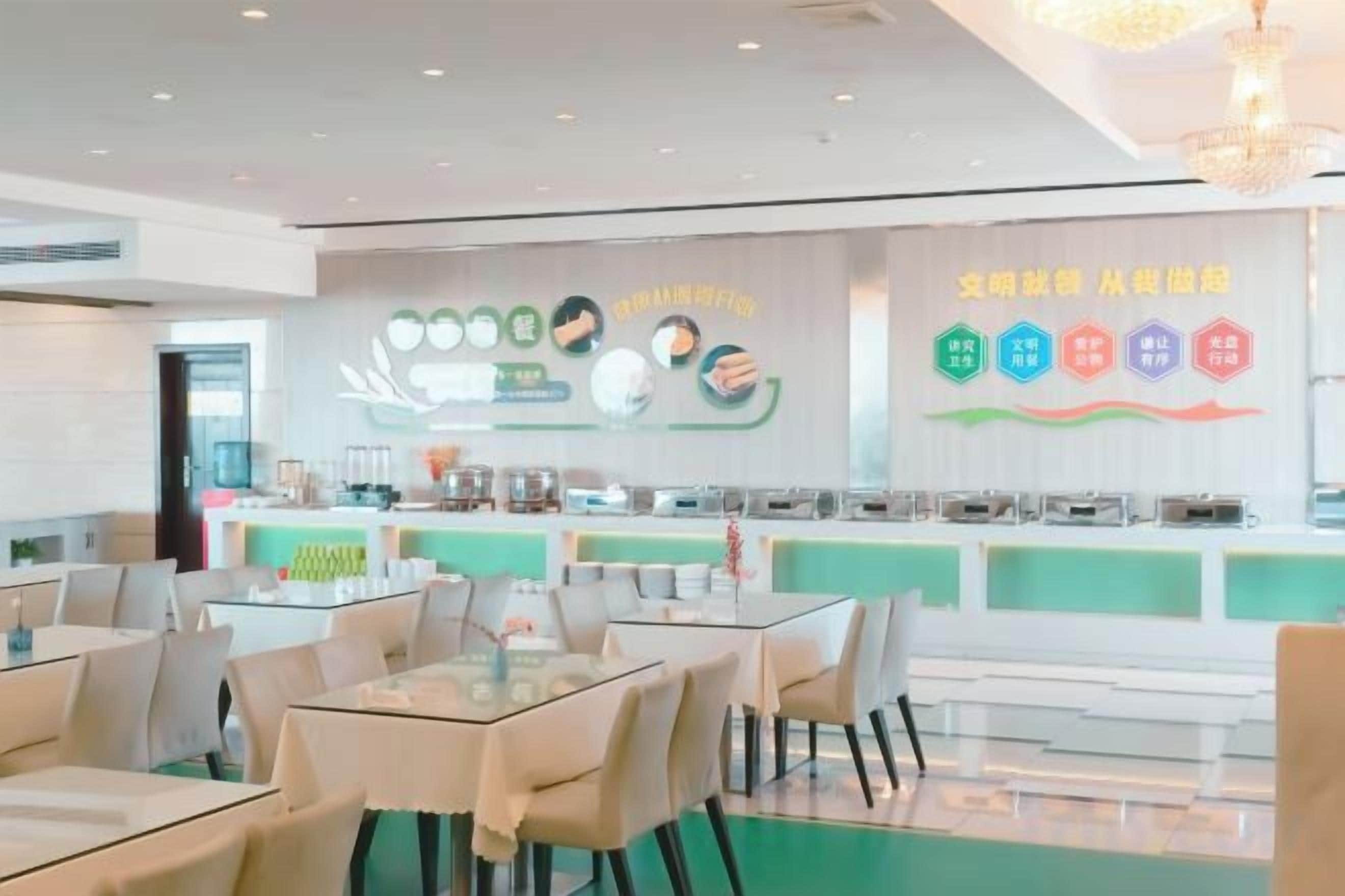 A modern dining area with tables and chairs, a counter with food items, and a wall with food-related graphics.