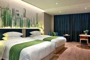 A hotel room with two beds, a cityscape mural, a small table with a plant, and a blue curtain. - Sun Grow Green Hotel (Qidong Chengxi) (Qidong)