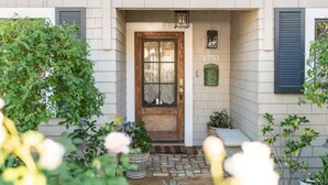 A building entrance with a wooden door, number 1751, and a small porch area with potted plants. - OCEAN & CITY VIEWS 1920s Monthly, RIVIERA HOME, 2 QUEEN BEDS, WALK TO STATE ST (Santa Barbara)