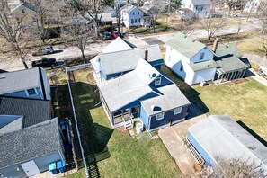 Residential neighborhood with single-family homes featuring various roof styles and well-maintained lawns.